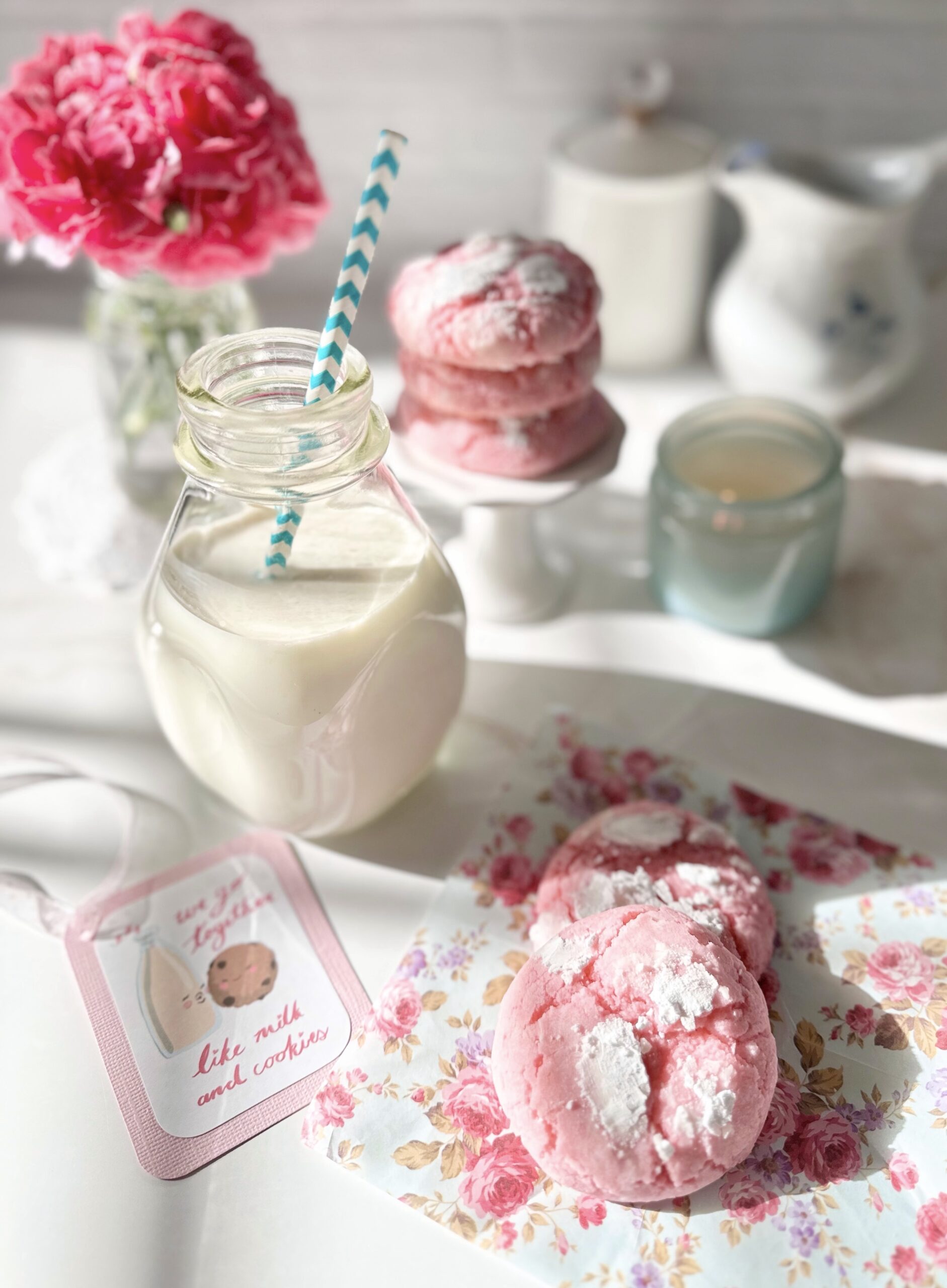 puffy cookies on a table with a glass of milk