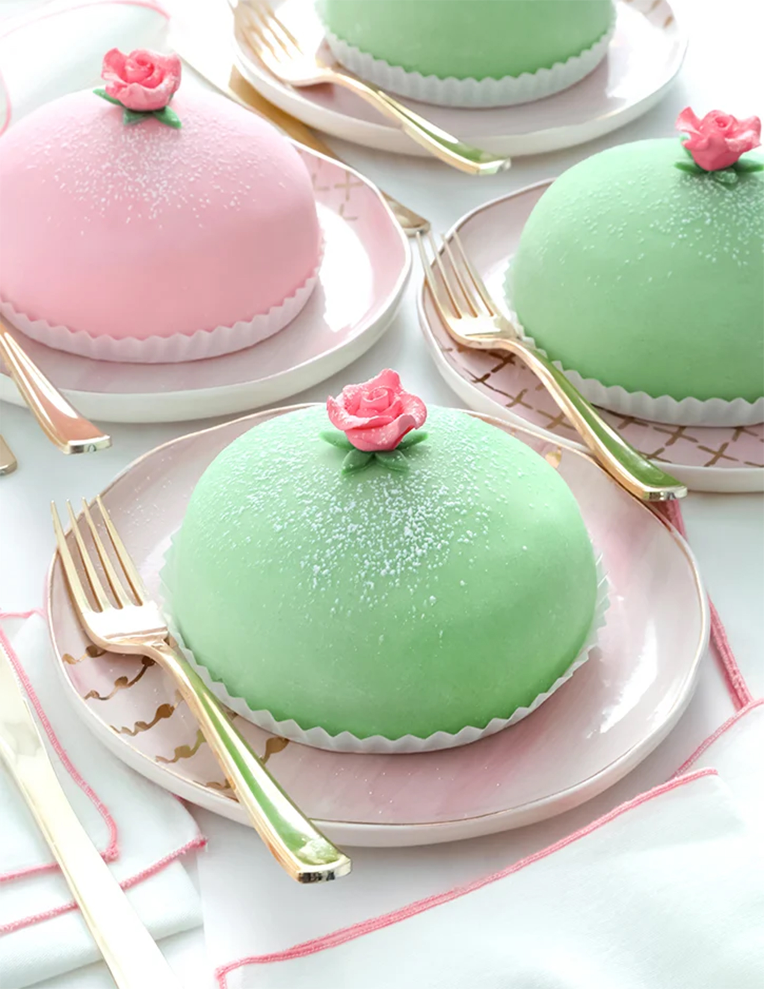 Green cake with rose on top placed on a table